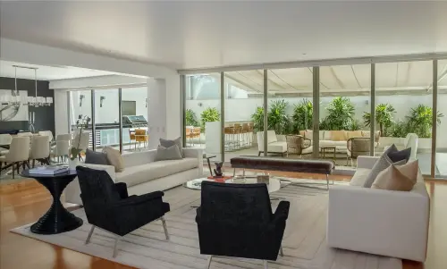 Imagem realista de sala bem iluminada, com uma bela cozinha ao fundo